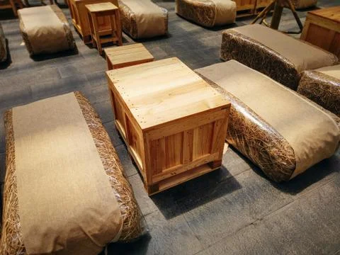 Interior Idea using Bags of Hay as Seats and Wooden Box as Table Stock Photos