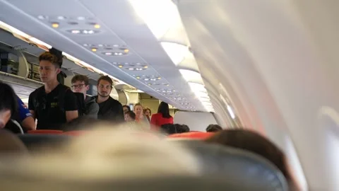Interior inside cabin of airplane with passangers boarding procedure to air.. Stock Footage 249666031
