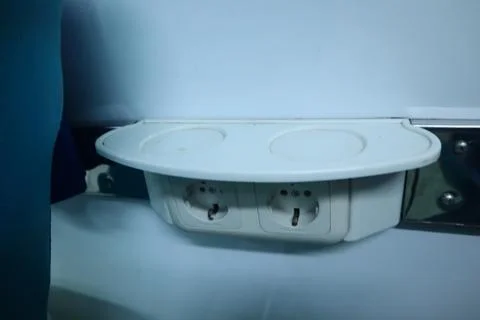 Interior inside an executive train. electric plugs. drinking stand. Stock Photos