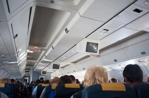 Interior inside of the plane with passengers. Stock Photos