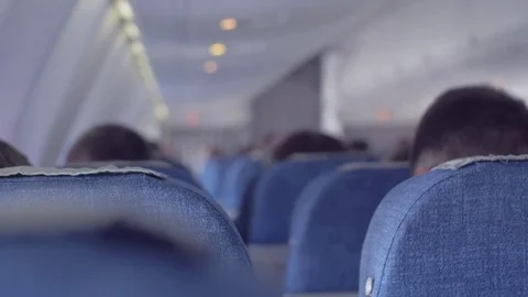 Interior inside plane with passengers on the seats. Airborne. Passengers sitting Stock Footage 74219687