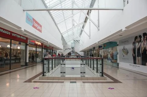 Interior inside of shopping centre mall with people socially distancing. Stock Photos