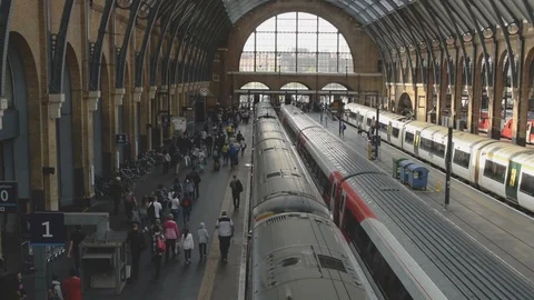 Interior of Kings Cross train station with commuters and trains at platforms Stock Footage 94493671