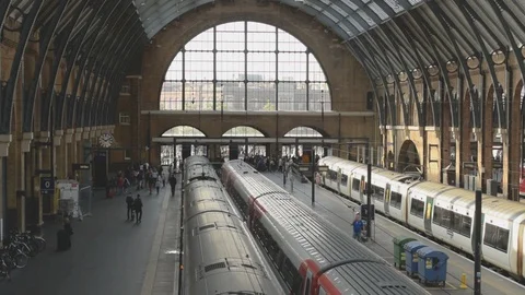 Interior of Kings Cross train station with commuters and trains at platforms Stock Footage 94494167