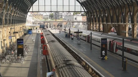 Interior of Kings Cross train station with commuters and trains at platforms Stock Footage 94497495