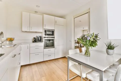 Interior of kitchen with table and modern appliances Stock Photos