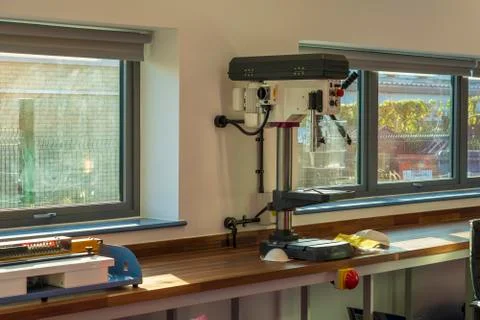 Interior of a large carpentry workshop full of workbenches and a variety of Stock Photos