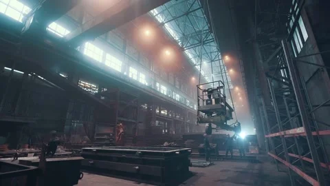 Interior of large foundry steel workshop with cast iron products, workers and Stock Footage 154049411