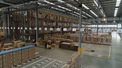 Interior of large stock warehouse with multiple shelves, drone aerial 4K Stock Footage 101184490