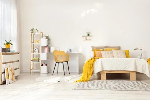 Interior of light children's room with bed and study table Stock Photos