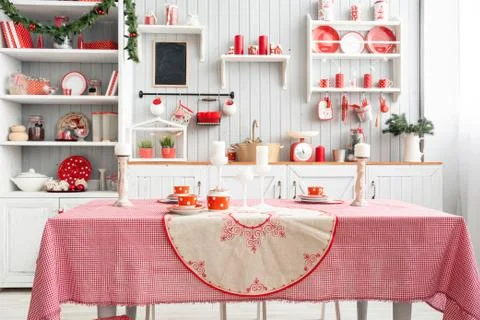 Interior light grey kitchen and red christmas decor. Preparing lunch at home on Stock Photos