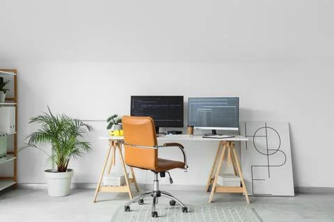 Interior of light office with programmer's workplace and palm tree Stock-Fotos