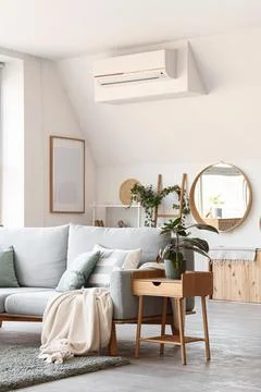 Interior of living room with sofa, bedside table and houseplants Stock Photos