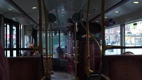 Interior of a London Bus Lower Deck with Empty Seats and Passengers Sitting Stock Footage 310259143