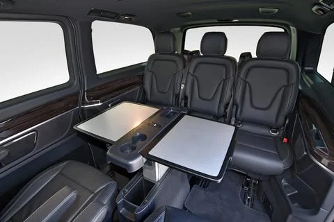 Interior of luxury van with comfortable leather seats and table Stock Photos