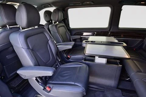 Interior of luxury van with comfortable leather seats and table Stock Photos