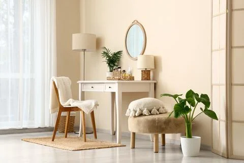 Interior of makeup room with table, lamps and pouf Stock Photos