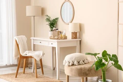 Interior of makeup room with table, lamps and pouf Stock Photos