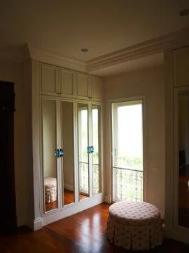 The interior of mirrored wardrobe with reflection of the background Stock Photos