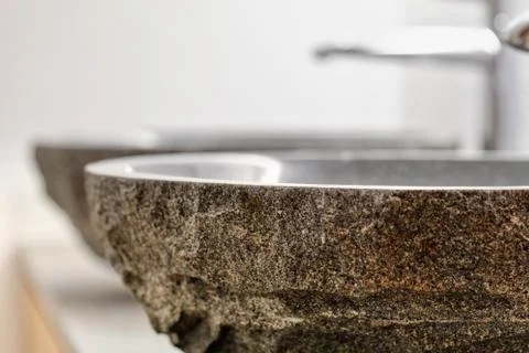 Interior of a modern bathroom with two stone sinks standing on brown furnitur Stock Photos