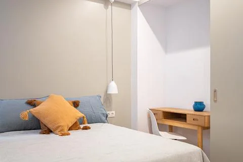 Interior of modern bedroom with small table and chair. Bright room with pleasant Stock Photos