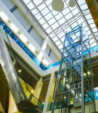 The interior of a modern building with an elevator. Glass roof, glass Elevator Stock Photos