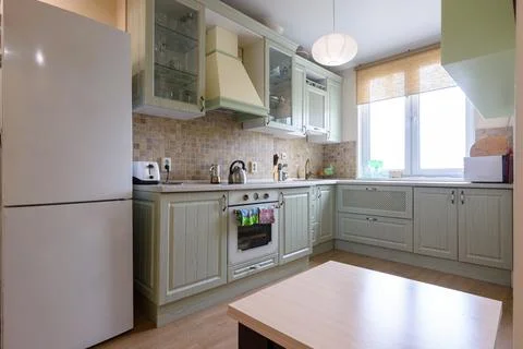 Interior of a modern classic kitchen with a corner kitchen set by the window Foto stock
