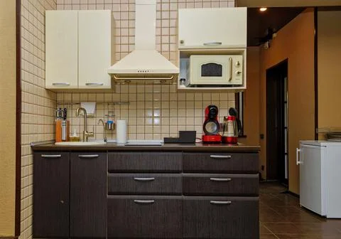 Interior of a modern comfortable kitchen. Beige shades , an island in the Stock Photos