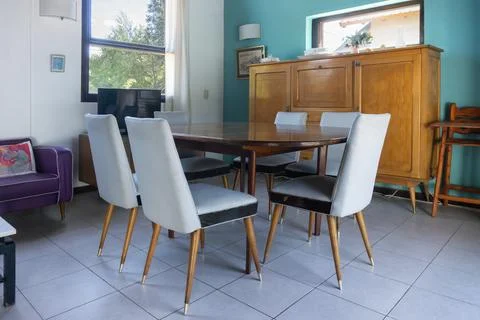 Interior of a modern dining room with a table and chairs. Stock Photos