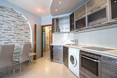 Interior of a modern kitchen with built-in appliances in gray tones Stock Photos