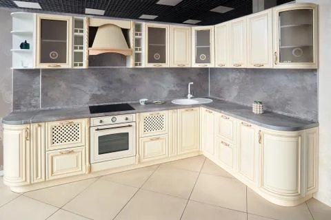 Interior of modern kitchen in classic style with golden elements in beige col Stock Photos