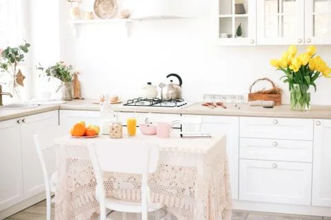 Interior of modern kitchen with fresh spring flowers. Stock Photos