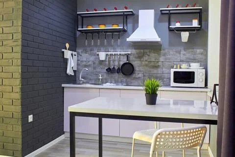 Interior of a modern kitchen. Small but cozy kitchen. In the foreground is a  Stock Photos