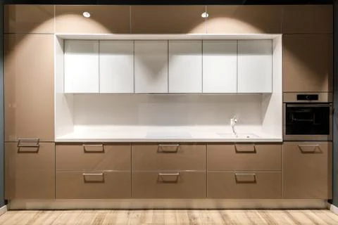 Interior of modern kitchen with stylish design in brown and white colors Stock Photos