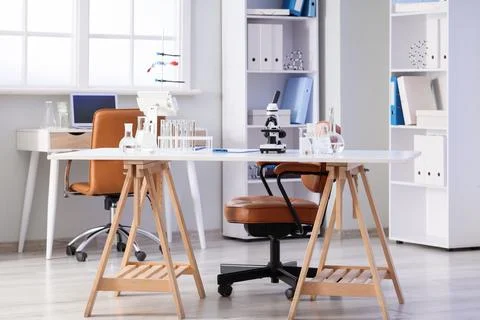 Interior of modern laboratory with microscope and different water samples in  Фото
