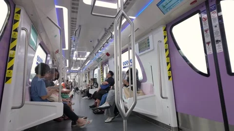 Interior of a modern LRT3 train carriage with passengers seated during a journey Stock Footage 342403990
