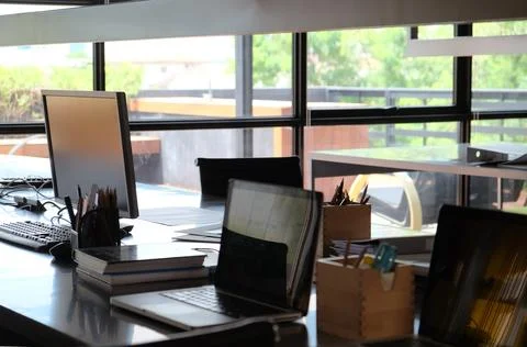Interior of a modern office with computers and documents on the table Stock Photos