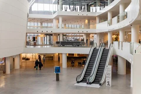 Interior of modern public cultural complex with visitors. Large museum lobby Stock Photos