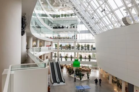 Interior of modern public cultural complex with atrium and glass roof. Stock Photos