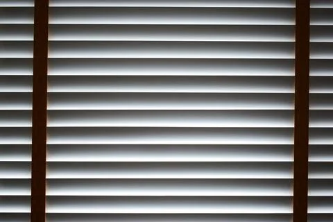 Interior of a modern room with horizontal window blinds, natural daylight. Stock Photos