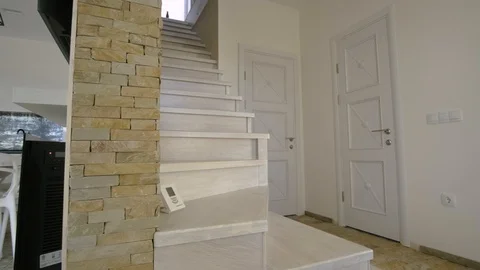 Interior of modern spacious kitchen with white walls, decorative wooden elements Video stock 123973472