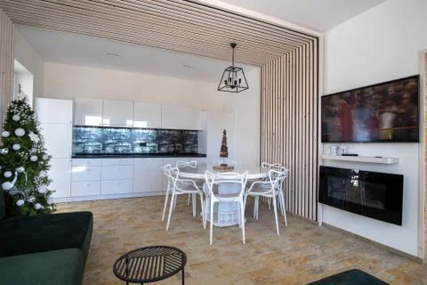 Interior of modern spacious kitchen with white walls, decorative wooden eleme Stock Photos