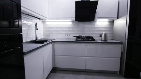 Interior of modern tech kitchen white. LED lighting furniture Video stock 98004360