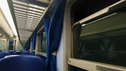 Interior of a Modern Train at Night with Blue Curtains and Seats.  Stock Footage 231575037
