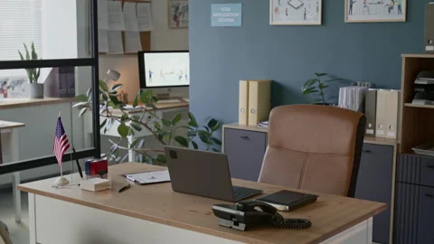Interior of Modern Visa Office with Laptop and Telephone on Wooden Desk Stock Footage 311024407
