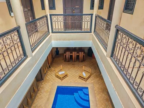 Interior of a Moroccan riad with a small pool in the middle Фото