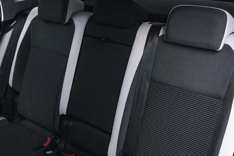 Interior of new car is viewed from inside. Passenger seats in back. Sofa and Stock-Fotos