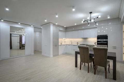 Interior of new spacious white kitchen after renovation in studio apartmen Stock Photos