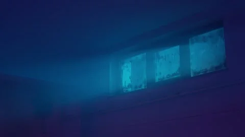 Interior night shot of an empty basement. Blue light, dirty window and fan.  Vídeo Stock 236090405