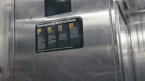 Interior of a NYC subway car in motion, with orange and yellow seats Stock Footage 309706975